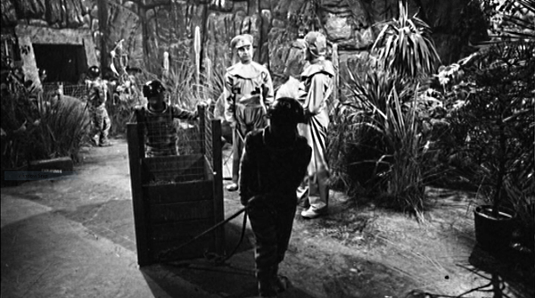 Two colonists watch alien miners