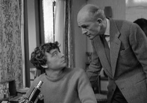 Father and son with microscope