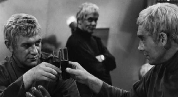 Two men toasting drinks