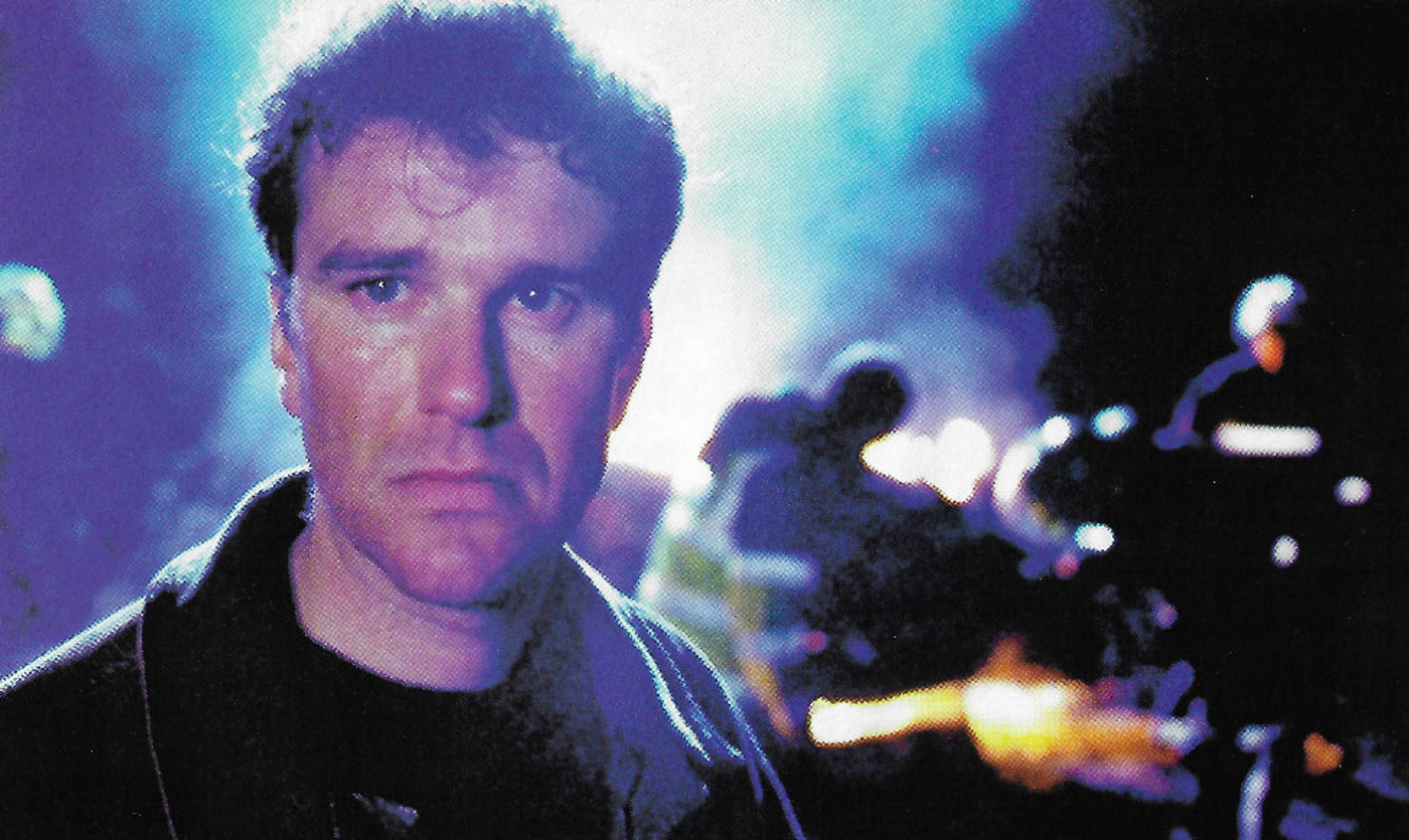 Man in front of a crashed car
